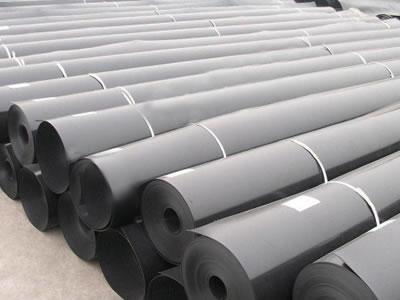 Many rolls of black ECB geomembrane are lying on the ground orderly, and their two sides are tied up by white ropes.