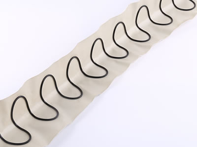 Long piece of spring semicircle tube in profile is lying on the white background.