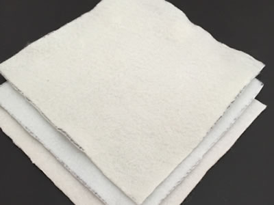 Three pieces of white short fiber geotextile fabric sample in different weight are lying on the black background.